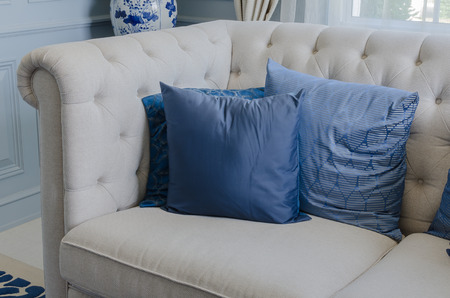 34872356 - blue pillows on white sofa in luxury living room